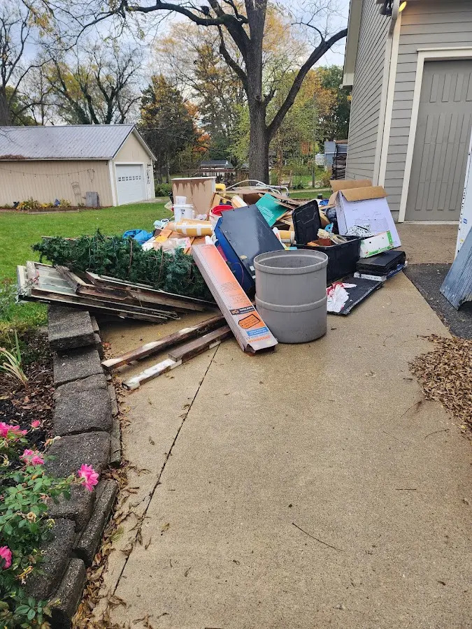 Dumpster being loaded with debris for 12 Yard Dumpster Rental in Castroville
